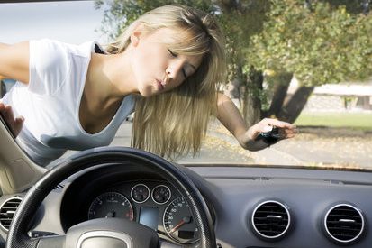 Image of woman in white tshirt kissing the windshield of her newly purchased vehicle.